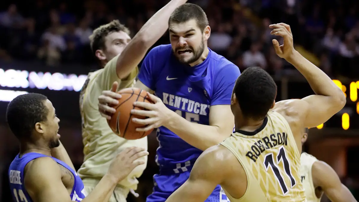 FILE - Kentucky forward Isaac Humphries, center, grabs a rebound in front of Vanderbilt's Luke Kornet, second from left, and Jeff Roberson (11) during the first half of an NCAA college basketball game on Jan. 10, 2017, in Nashville, Tenn. Melbourne United starting center Isaac Humphries has announced that he is gay and said he hopes his decision to publicly announce his sexuality will lead to more professional sportsmen doing the same. (AP Photo/Mark Humphrey, File)