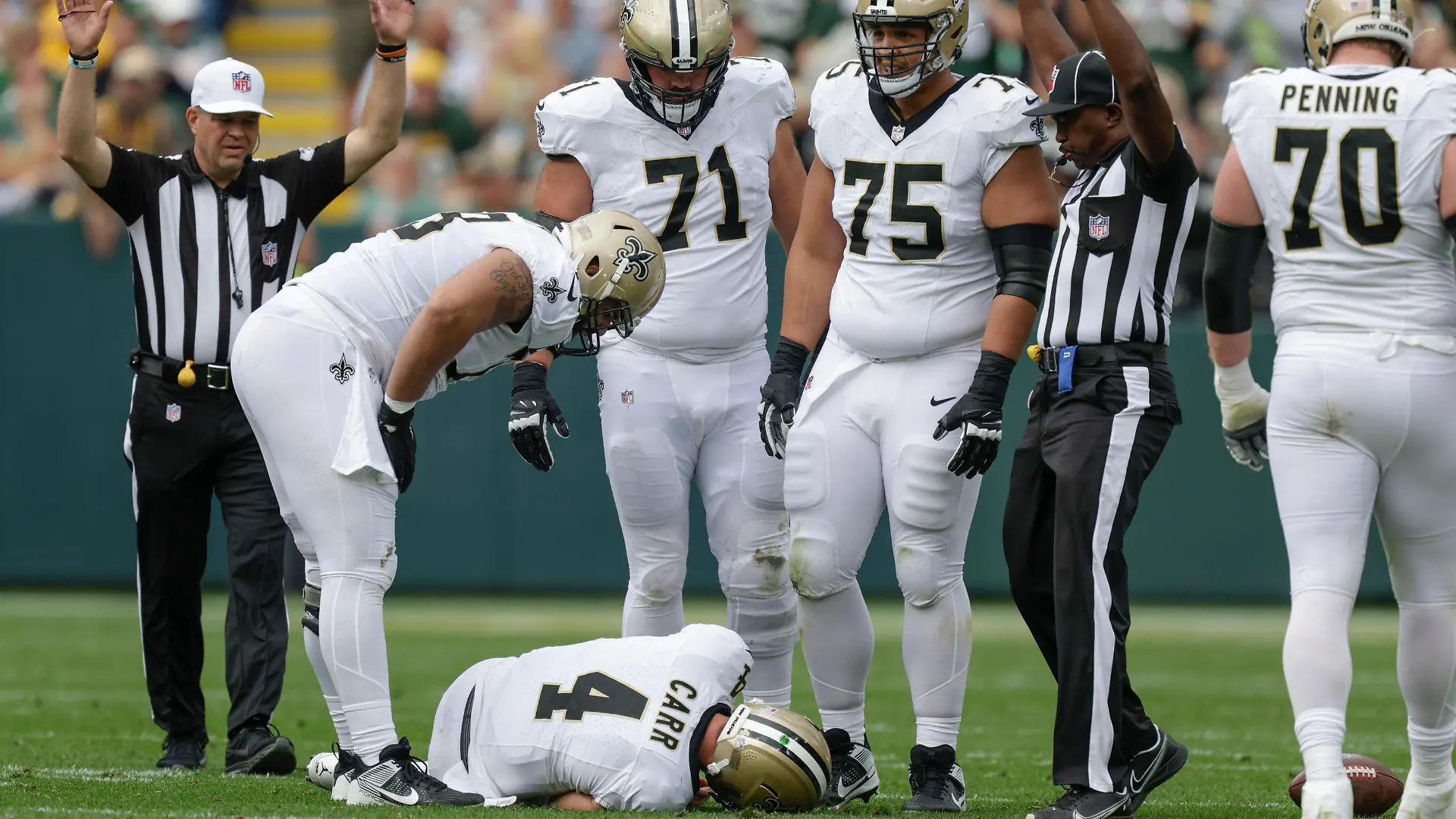 New Orleans Saints quarterback Derek Carr (4) lays on the turf after being hurt while being sacked during the second half of an NFL football game against the Green Bay Packers Sunday, Sept. 24, 2023, in Green Bay, Wis. (AP Photo/Matt Ludtke)
