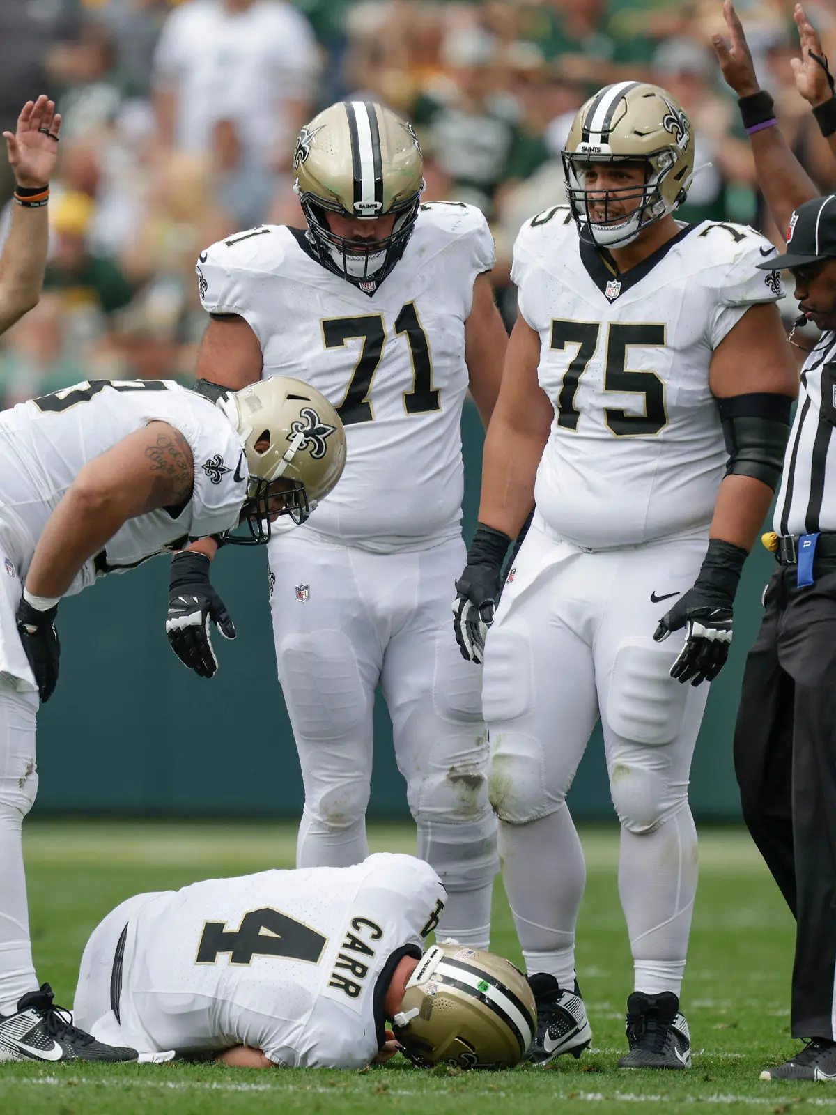 New Orleans Saints quarterback Derek Carr (4) lays on the turf after being hurt while being sacked during the second half of an NFL football game against the Green Bay Packers Sunday, Sept. 24, 2023, in Green Bay, Wis. (AP Photo/Matt Ludtke)
