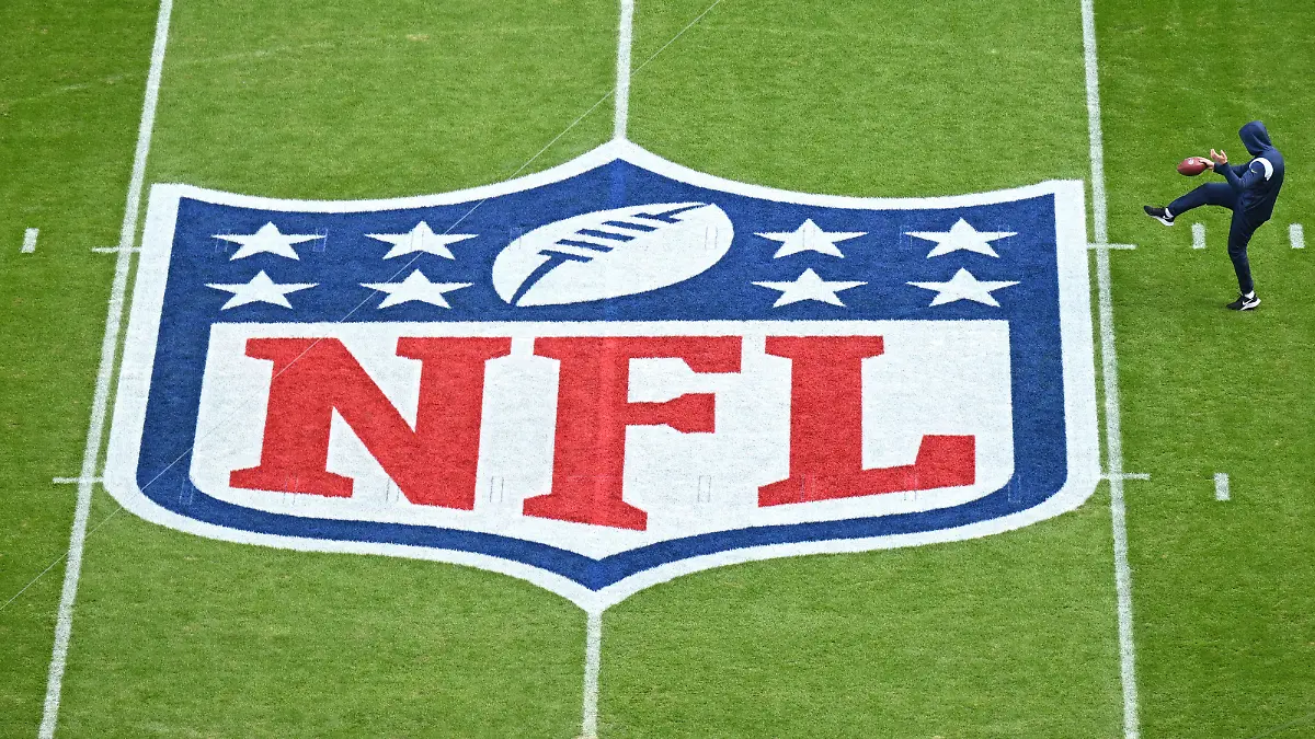 MUNICH, GERMANY - NOVEMBER 13: A player warms up next to the NFL logo painted on the field prior to the NFL match between Seattle Seahawks and Tampa Bay Buccaneers at Allianz Arena on November 13, 2022 in Munich, Germany. (Photo by Sebastian Widmann/Getty Images)