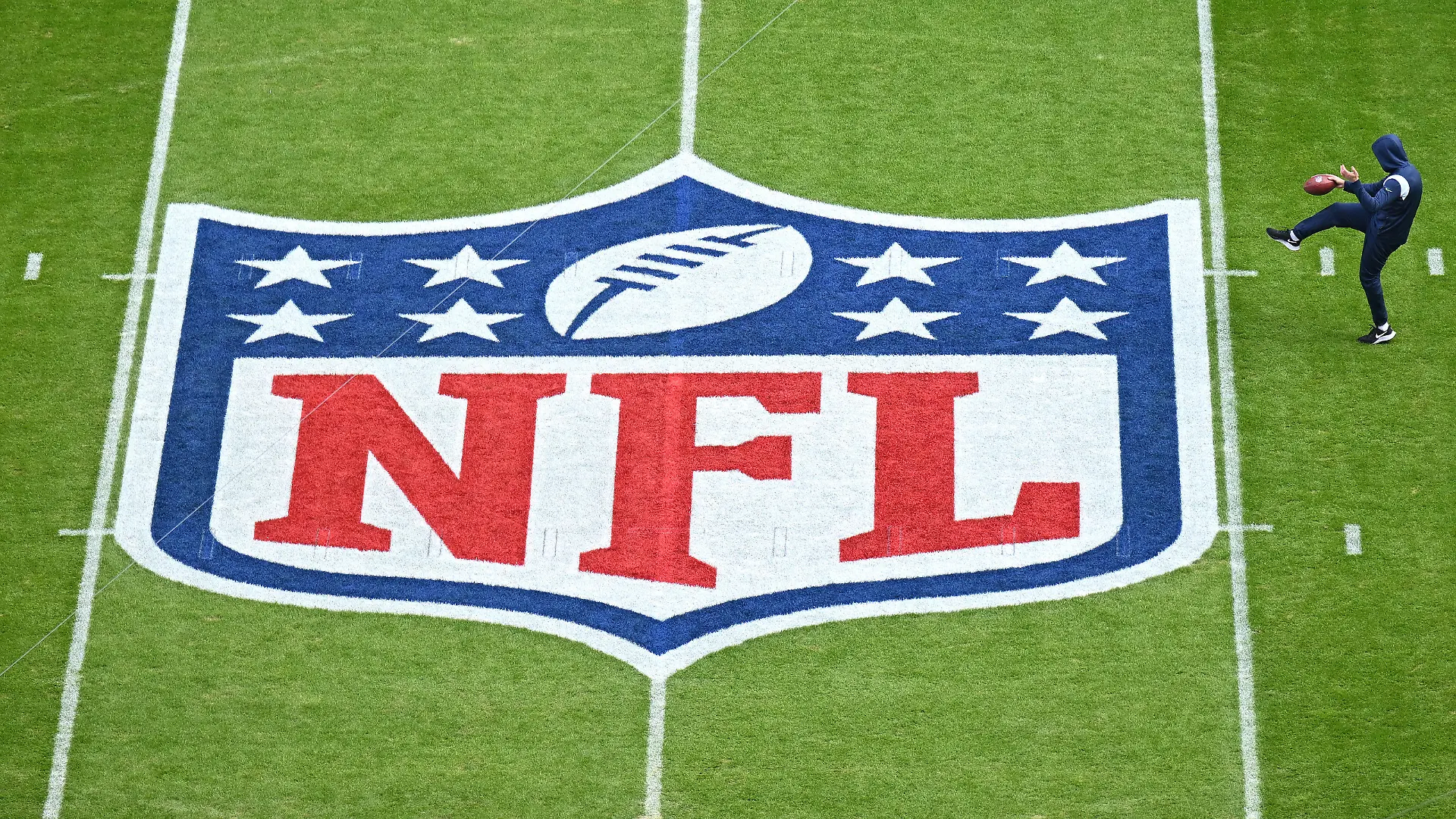 MUNICH, GERMANY - NOVEMBER 13: A player warms up next to the NFL logo painted on the field prior to the NFL match between Seattle Seahawks and Tampa Bay Buccaneers at Allianz Arena on November 13, 2022 in Munich, Germany. (Photo by Sebastian Widmann/Getty Images)