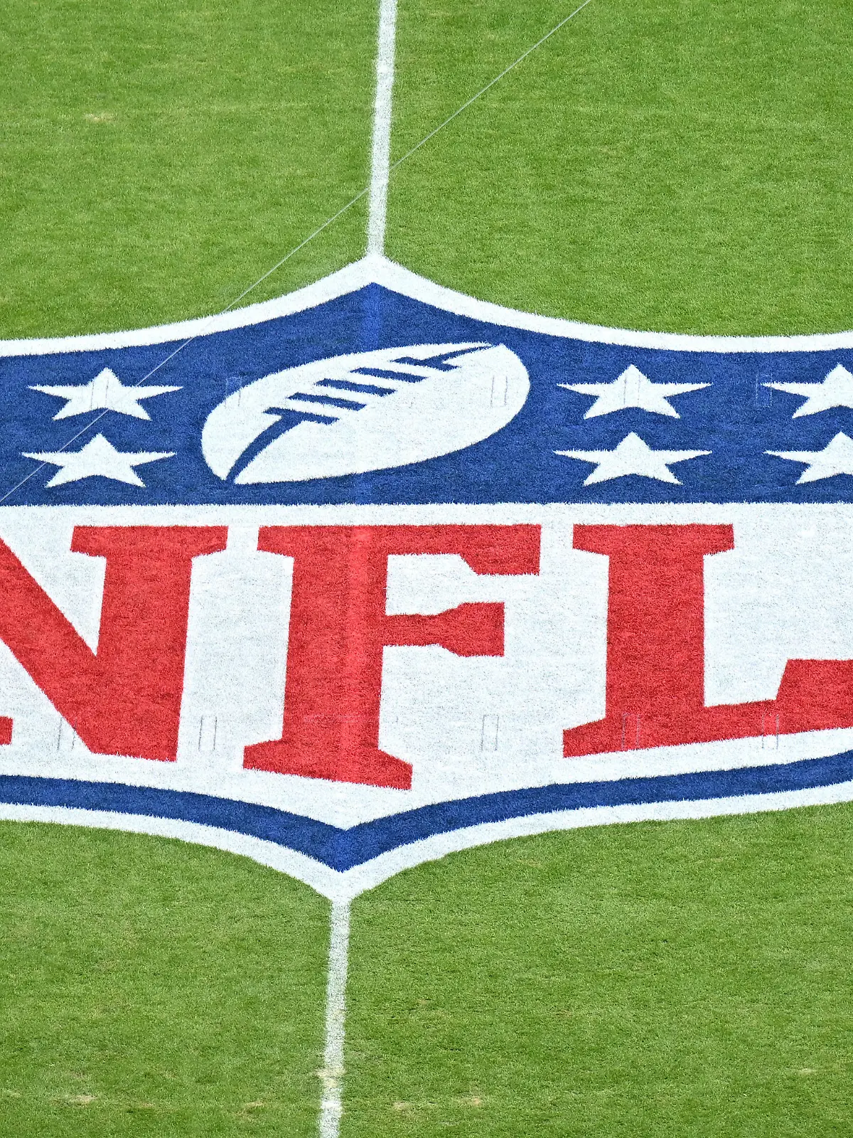 MUNICH, GERMANY - NOVEMBER 13: A player warms up next to the NFL logo painted on the field prior to the NFL match between Seattle Seahawks and Tampa Bay Buccaneers at Allianz Arena on November 13, 2022 in Munich, Germany. (Photo by Sebastian Widmann/Getty Images)