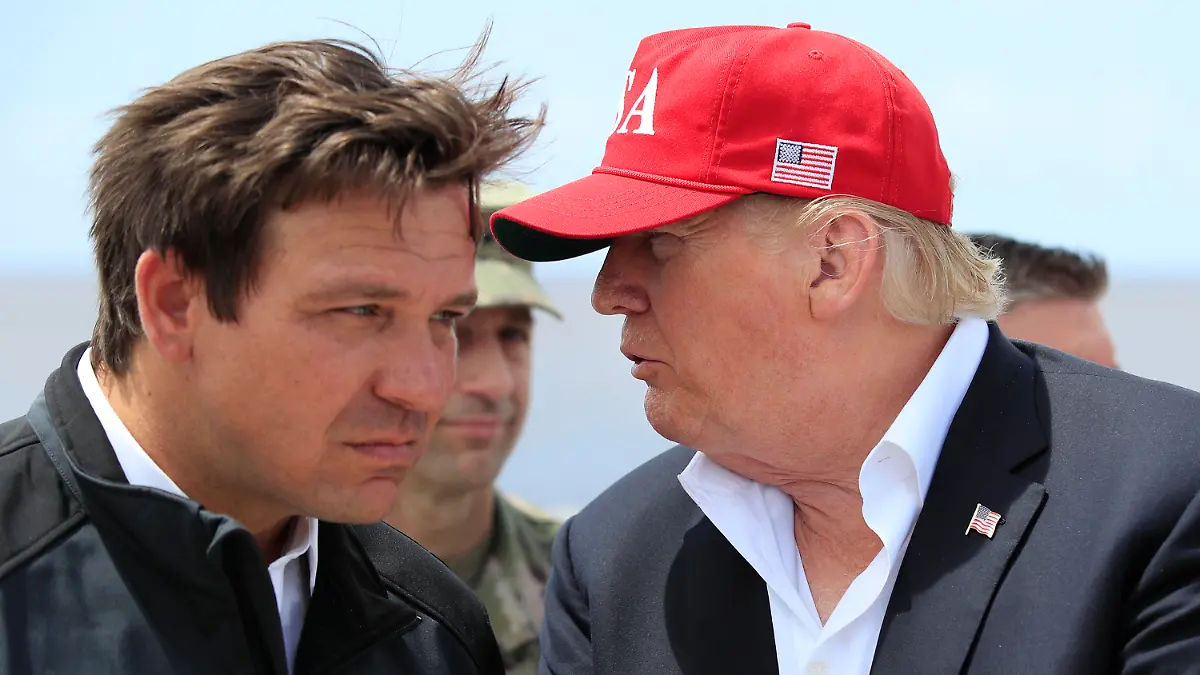 FILE - President Donald Trump talks to Florida Gov. Ron DeSantis, left, during a visit to Lake Okeechobee and Herbert Hoover Dike at Canal Point, Fla., March 29, 2019. (AP Photo/Manuel Balce Ceneta, File)