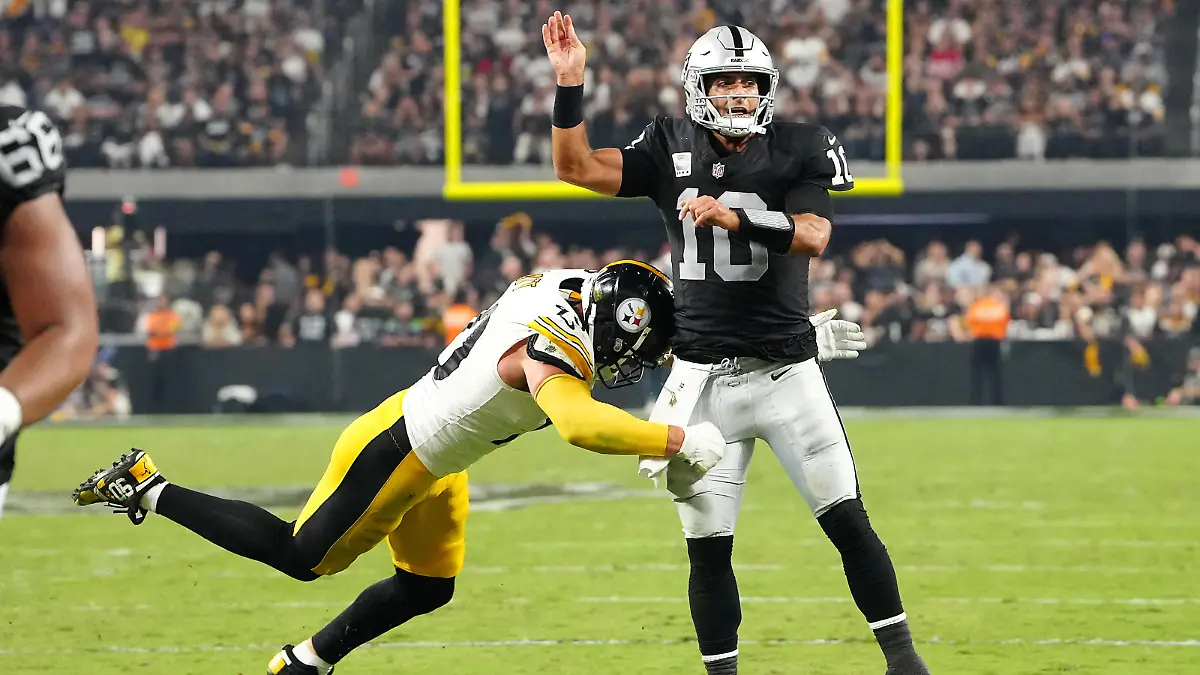 Sep 24, 2023; Paradise, Nevada, USA; Las Vegas Raiders quarterback Jimmy Garoppolo (10) is hit by Pittsburgh Steelers linebacker T.J. Watt (90) after making a pass during the fourth quarter at Allegiant Stadium. Mandatory Credit: Stephen R. Sylvanie-USA TODAY Sports