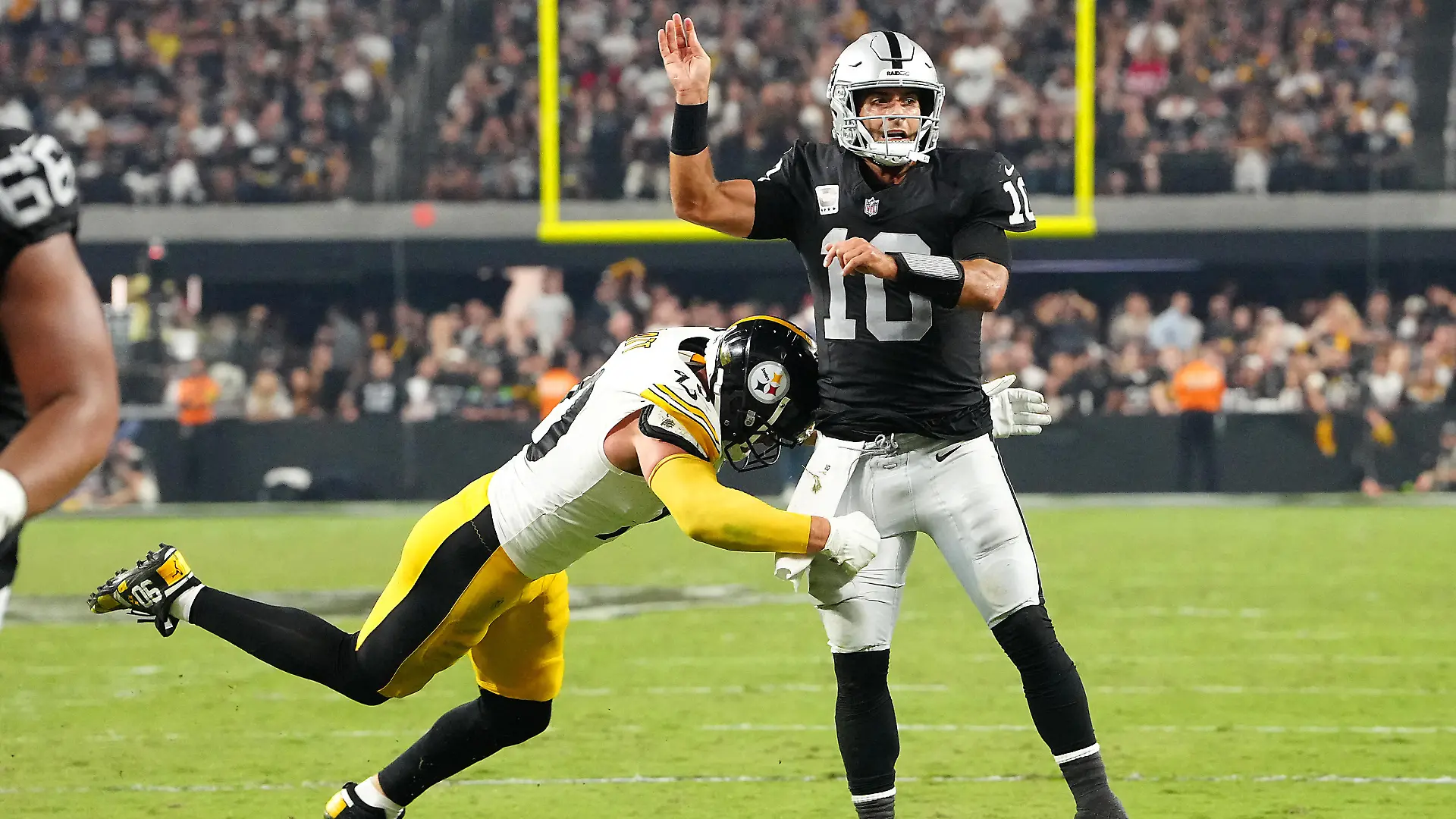 Sep 24, 2023; Paradise, Nevada, USA; Las Vegas Raiders quarterback Jimmy Garoppolo (10) is hit by Pittsburgh Steelers linebacker T.J. Watt (90) after making a pass during the fourth quarter at Allegiant Stadium. Mandatory Credit: Stephen R. Sylvanie-USA TODAY Sports