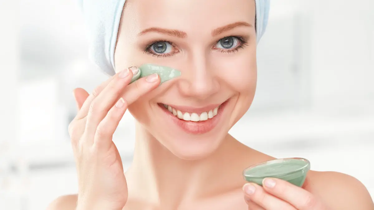 beautiful girl in the bathroom and mask for facial skin care
