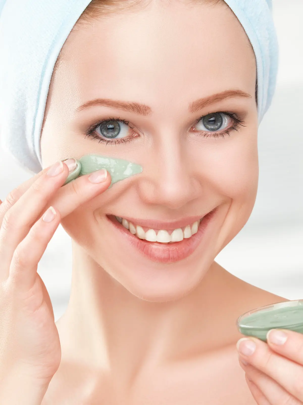 beautiful girl in the bathroom and mask for facial skin care