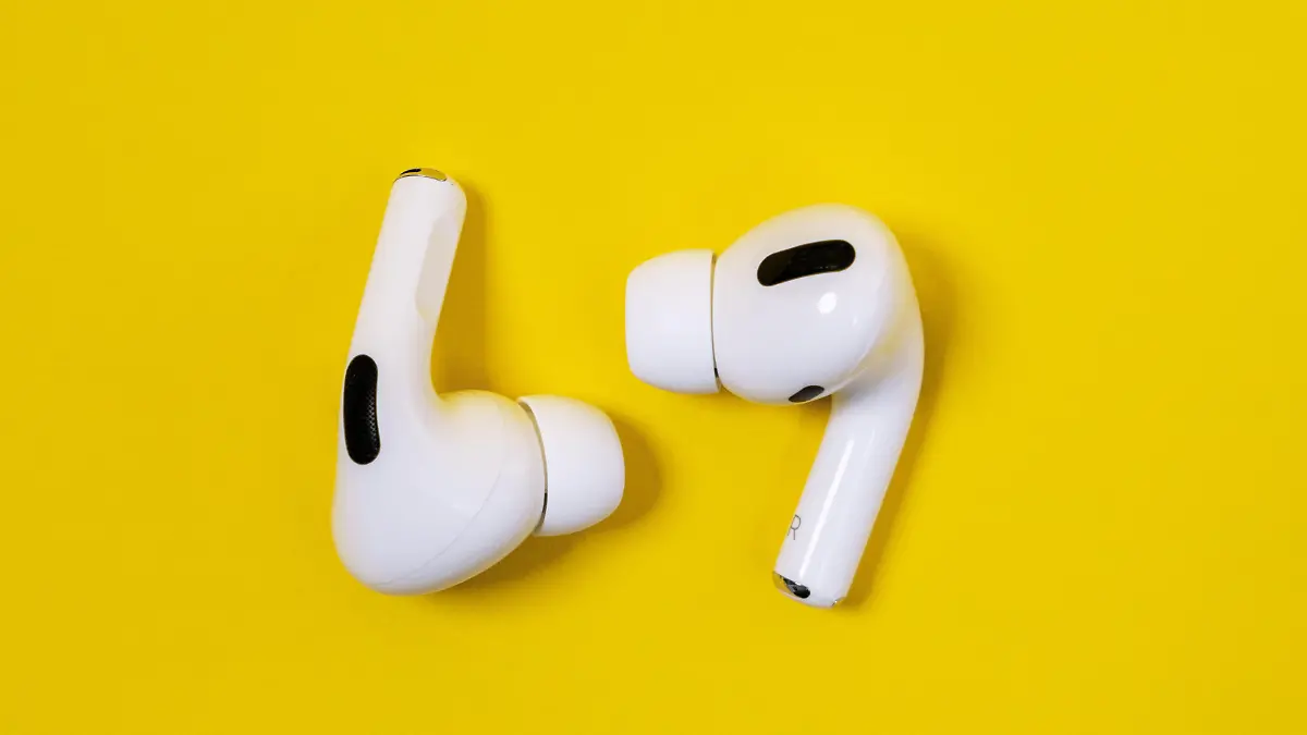 Rostov, Russia - July 06, 2020: Apple AirPods Pro on a yellow background. Silent wireless headphones close up.