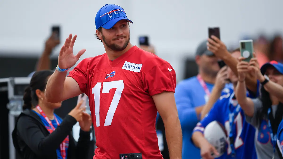 Buffalo Bills quarterback Josh Allen (17) waves to fans as he walks to the field before practice at the NFL football team's training camp in Pittsford, N.Y., Thursday, July 27, 2023. (AP Photo/Adrian Kraus)