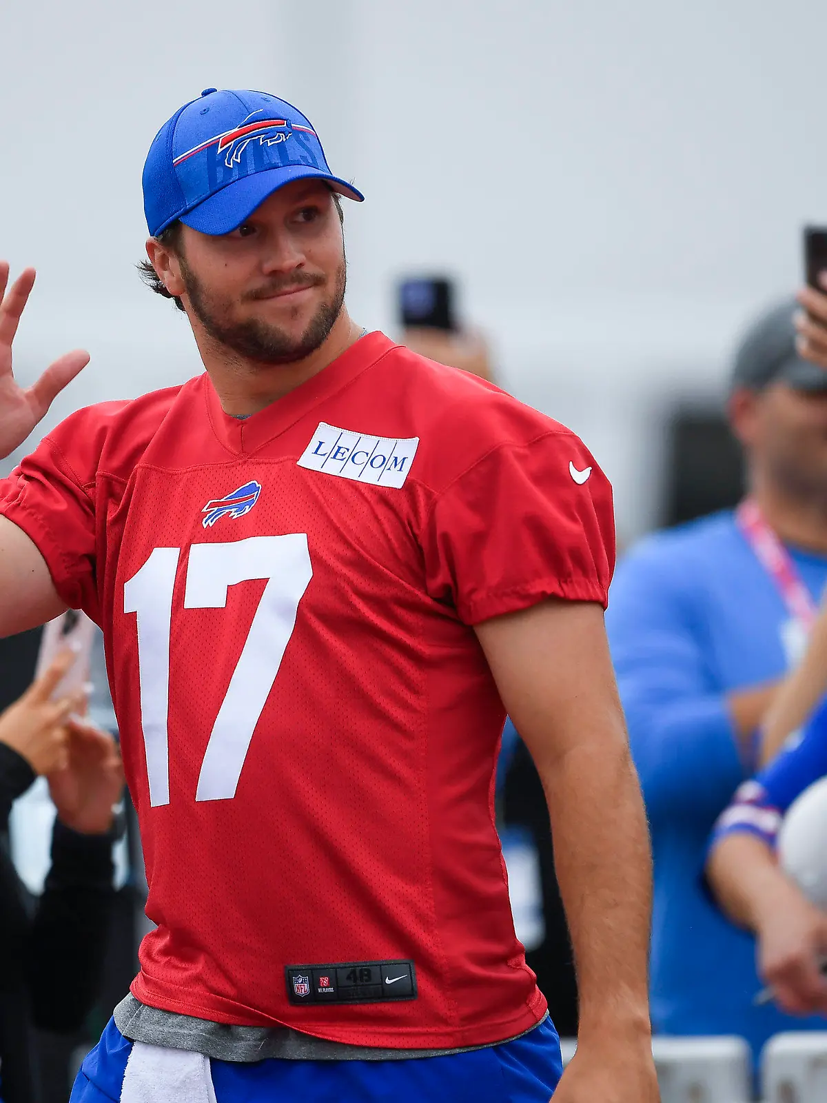 Buffalo Bills quarterback Josh Allen (17) waves to fans as he walks to the field before practice at the NFL football team's training camp in Pittsford, N.Y., Thursday, July 27, 2023. (AP Photo/Adrian Kraus)