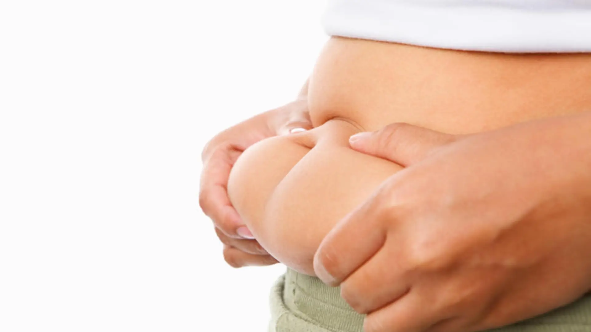 hand pinching fat on tummy for obese concept over white background