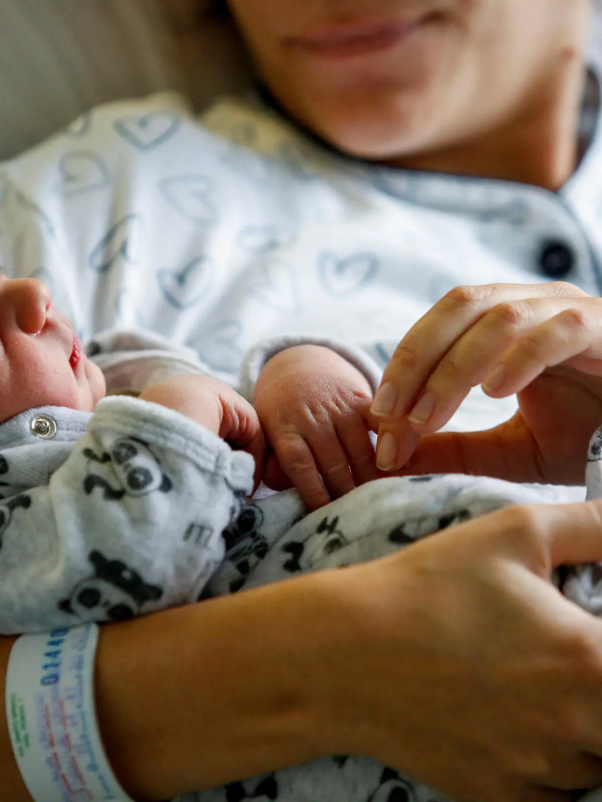 Newborn baby Leonardo rests on his mum's Viviana Valente arms, inside a room of the Santo Spirito Hospital, as the UN forecasts the world will reach 8 billion people around November 15, 2022, in Rome, Italy, November 14, 2022. REUTERS/Remo Casilli