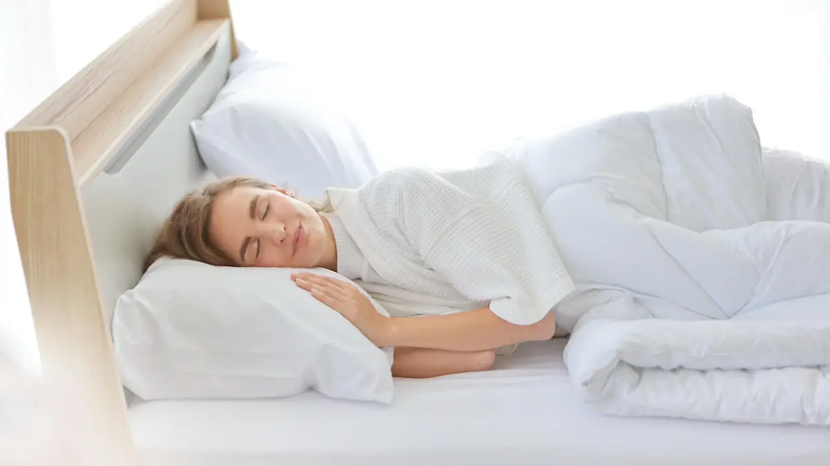 young beautiful woman sleeping in bed with relaxation and happy face in the morning