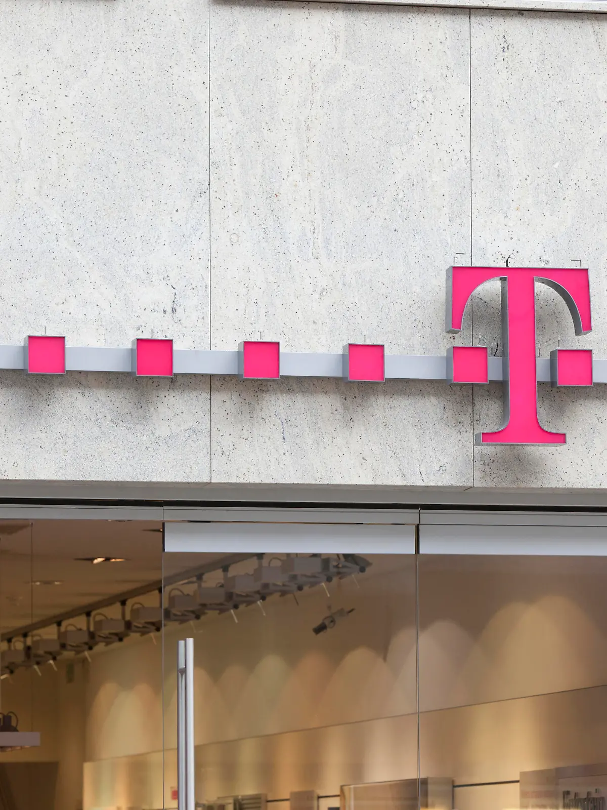 Munich, Germany - February 18, 2012: Logo of Deutsche Telekom on a shop in Munich, Germany. There are around 750 so called "T-Punkt" shops which sell products and services of Deutsche Telekom.