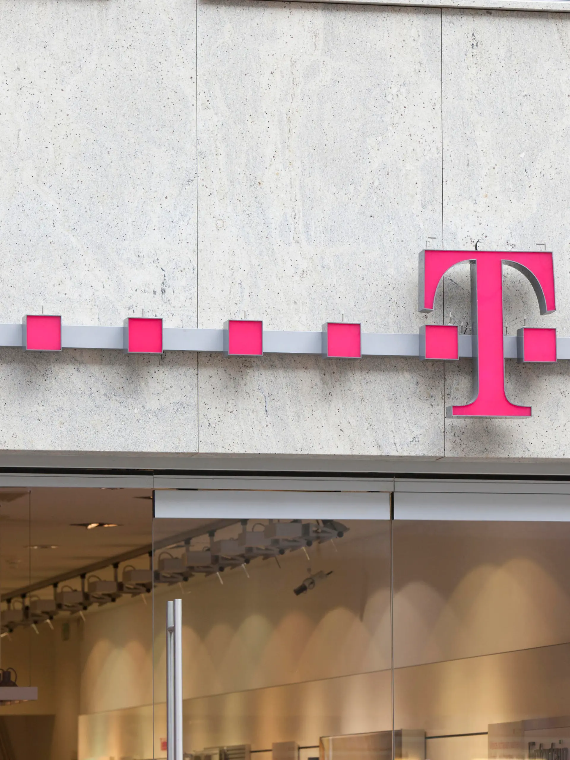 Munich, Germany - February 18, 2012: Logo of Deutsche Telekom on a shop in Munich, Germany. There are around 750 so called "T-Punkt" shops which sell products and services of Deutsche Telekom.