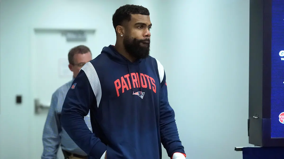 New England Patriots running back Ezekiel Elliott walks toward a podium to face reporters following an NFL football practice, Wednesday, Sept. 27, 2023, in Foxborough, Mass. (AP Photo/Steven Senne)