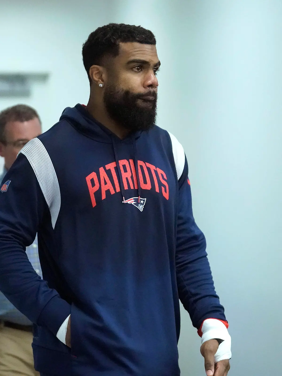 New England Patriots running back Ezekiel Elliott walks toward a podium to face reporters following an NFL football practice, Wednesday, Sept. 27, 2023, in Foxborough, Mass. (AP Photo/Steven Senne)