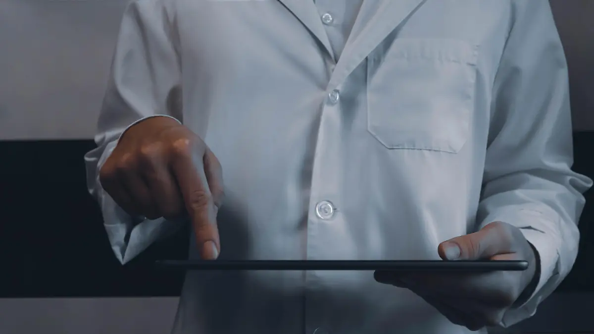 Digitalizing healthcare closeup concept image. Front view photo of male practitioner browsing records on tablet. Picture for web banner, landing page, blog, news and article. Website header design