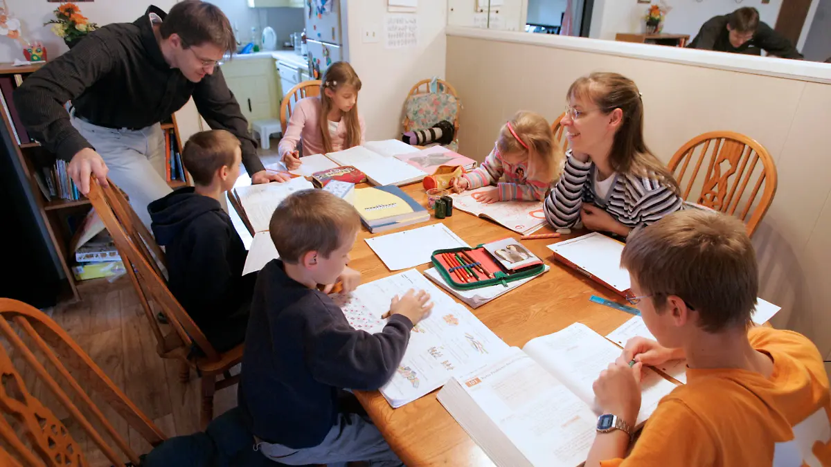 FILE -- In this March 13, 2009, file photo, Uwe Romeike, top left, and his wife Hannelore, second from right, teach their children at their home in Morristown, Tenn. The family fled Germany in order to home-school their children, and is asking the U.S. Supreme Court to grant them asylum. (AP Photo/Wade Payne, File)