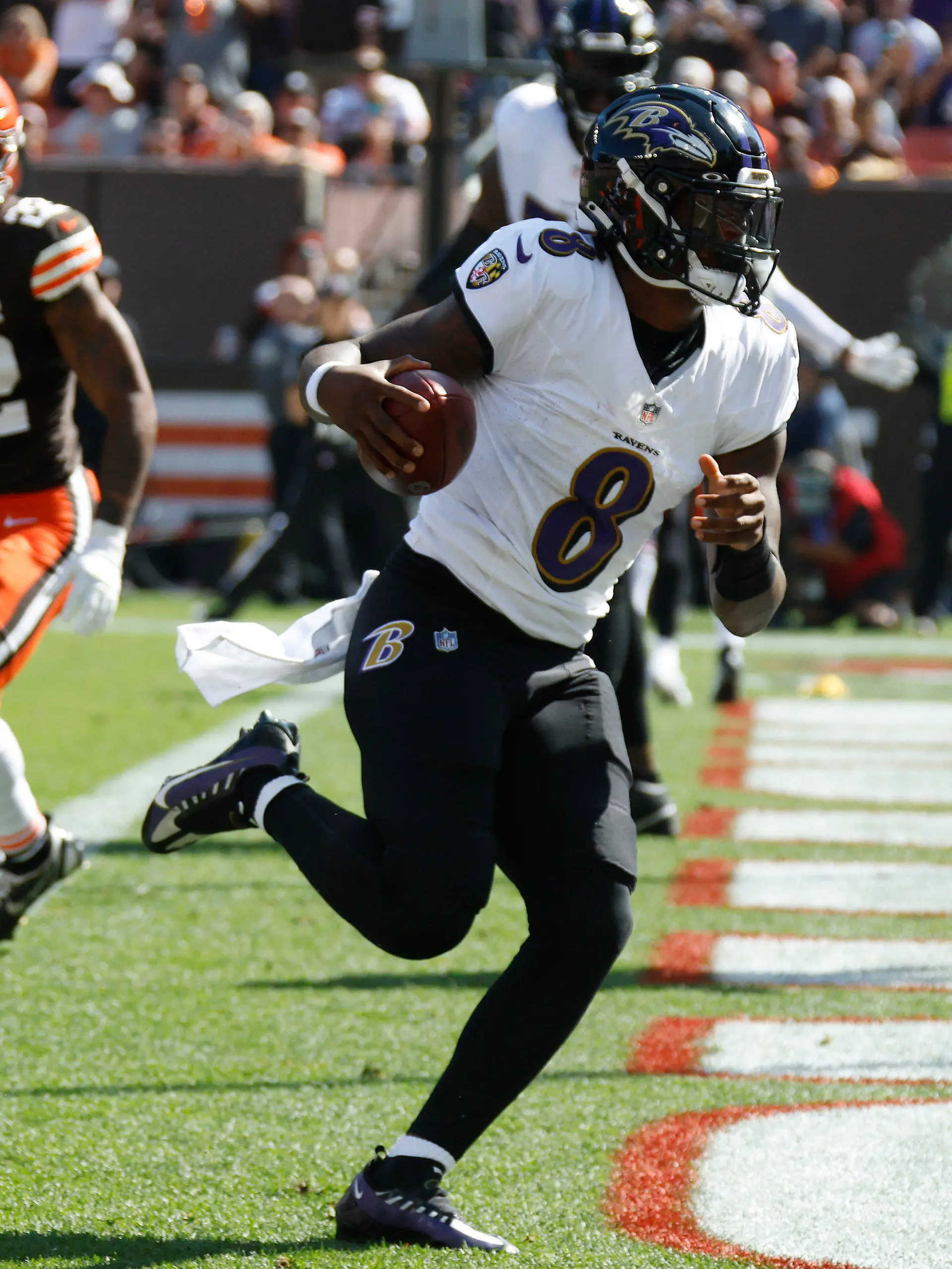 Baltimore Ravens quarterback Lamar Jackson (8) scores a 2-yard rushing touchdown during the first half of an NFL football game against the Cleveland Browns, Sunday, Oct. 1, 2023, in Cleveland. (AP Photo/Sue Ogrocki)