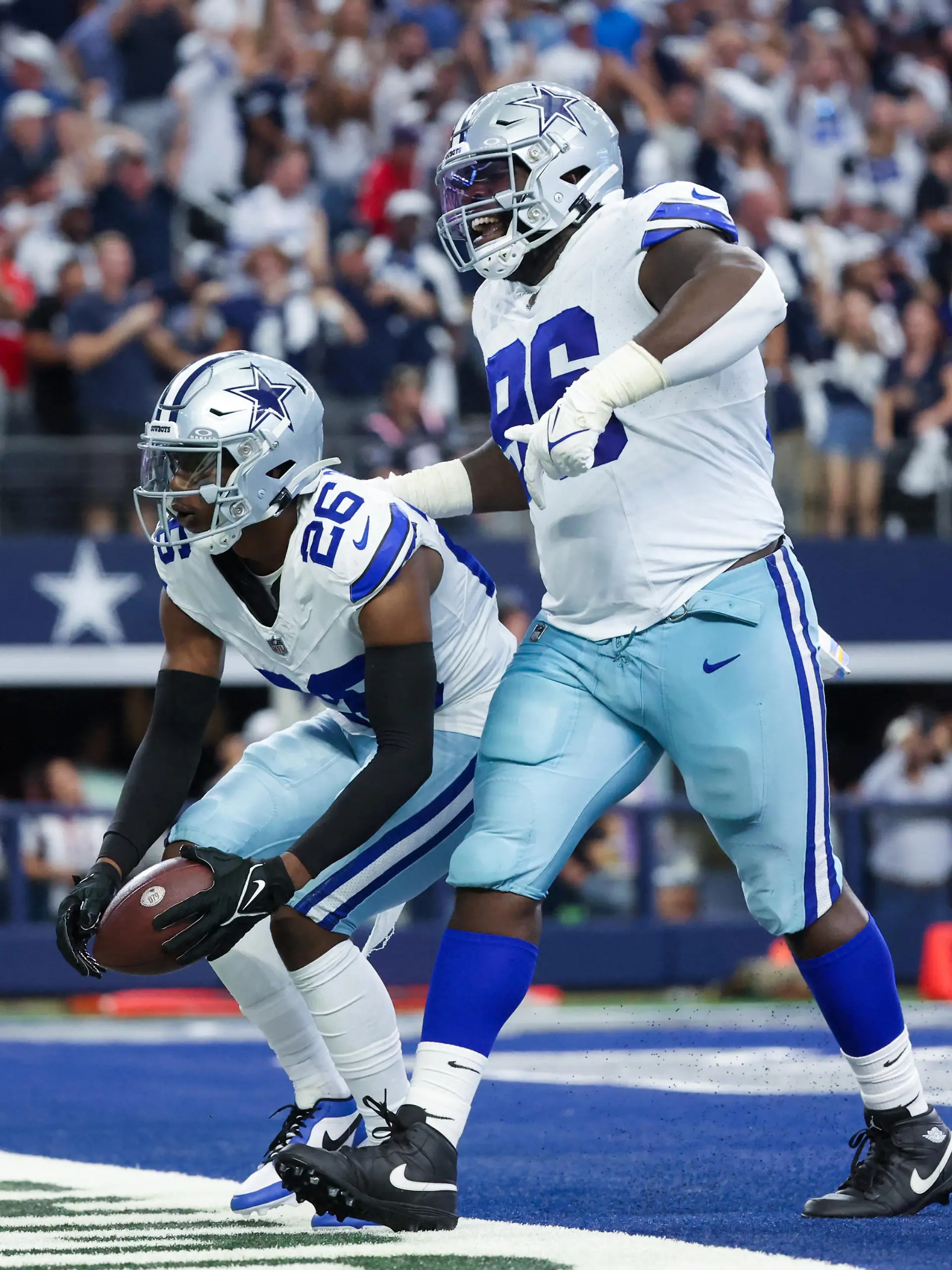 Oct 1, 2023; Arlington, Texas, USA;  Dallas Cowboys cornerback DaRon Bland (26) celebrates with Dallas Cowboys defensive tackle Neville Gallimore (96) after returning an interception for a touchdown  during the first half against the New England Patriots at AT&T Stadium. Mandatory Credit: Kevin Jairaj-USA TODAY Sports