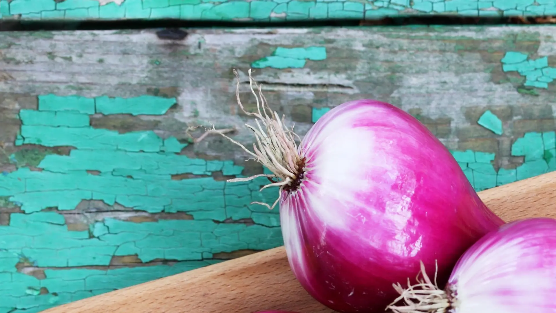 Fresh purple onion on a wooden board