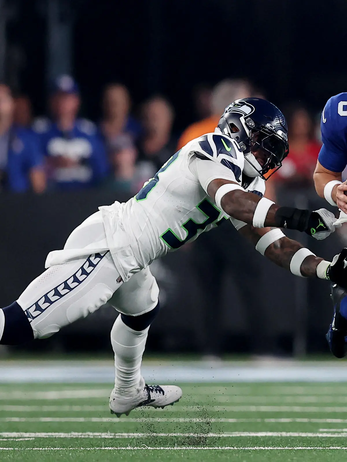 Oct 2, 2023; East Rutherford, New Jersey, USA; New York Giants quarterback Daniel Jones (8) runs with the ball against Seattle Seahawks safety Jamal Adams (33) during the first quarter at MetLife Stadium. Mandatory Credit: Brad Penner-USA TODAY Sports