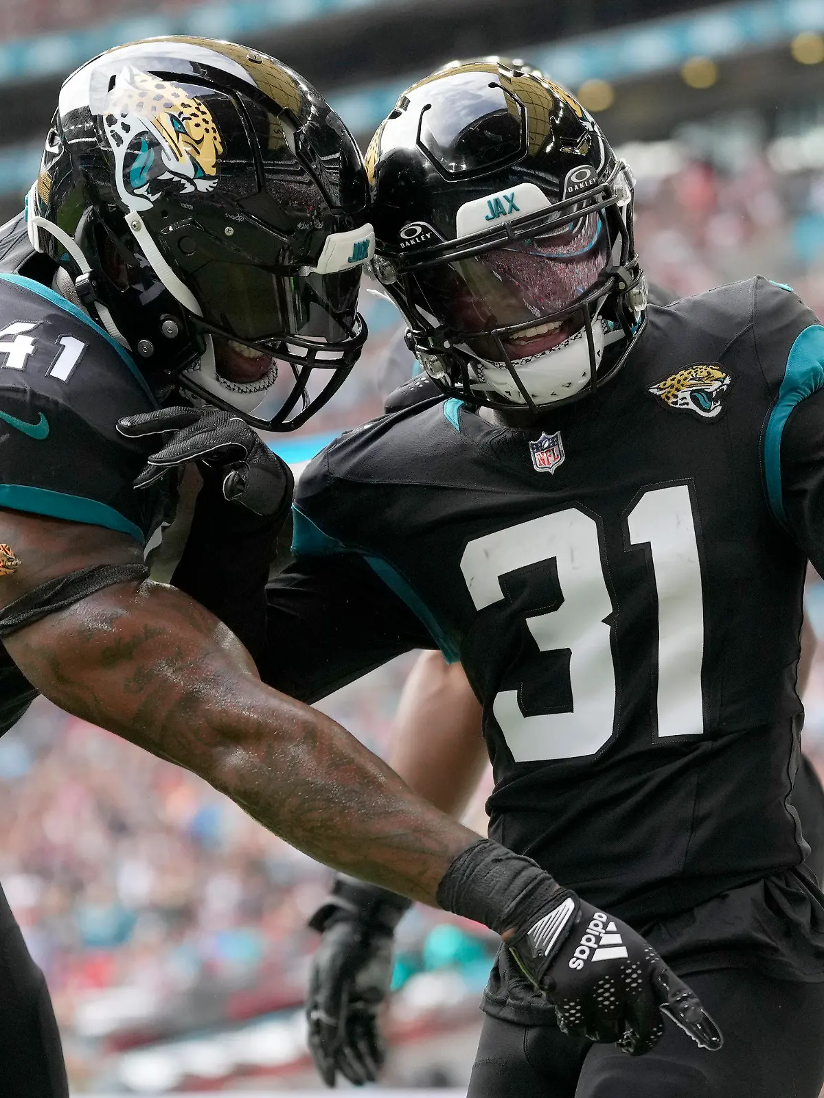 Jacksonville Jaguars cornerback Darious Williams (31) celebrates with Jacksonville Jaguars linebacker Josh Allen (41) after scoring a touchdown during an NFL football game between the Atlanta Falcons and the Jacksonville Jaguars at Wembley stadium in London, Sunday, Oct. 1, 2023. (AP Photo/Kirsty Wigglesworth)