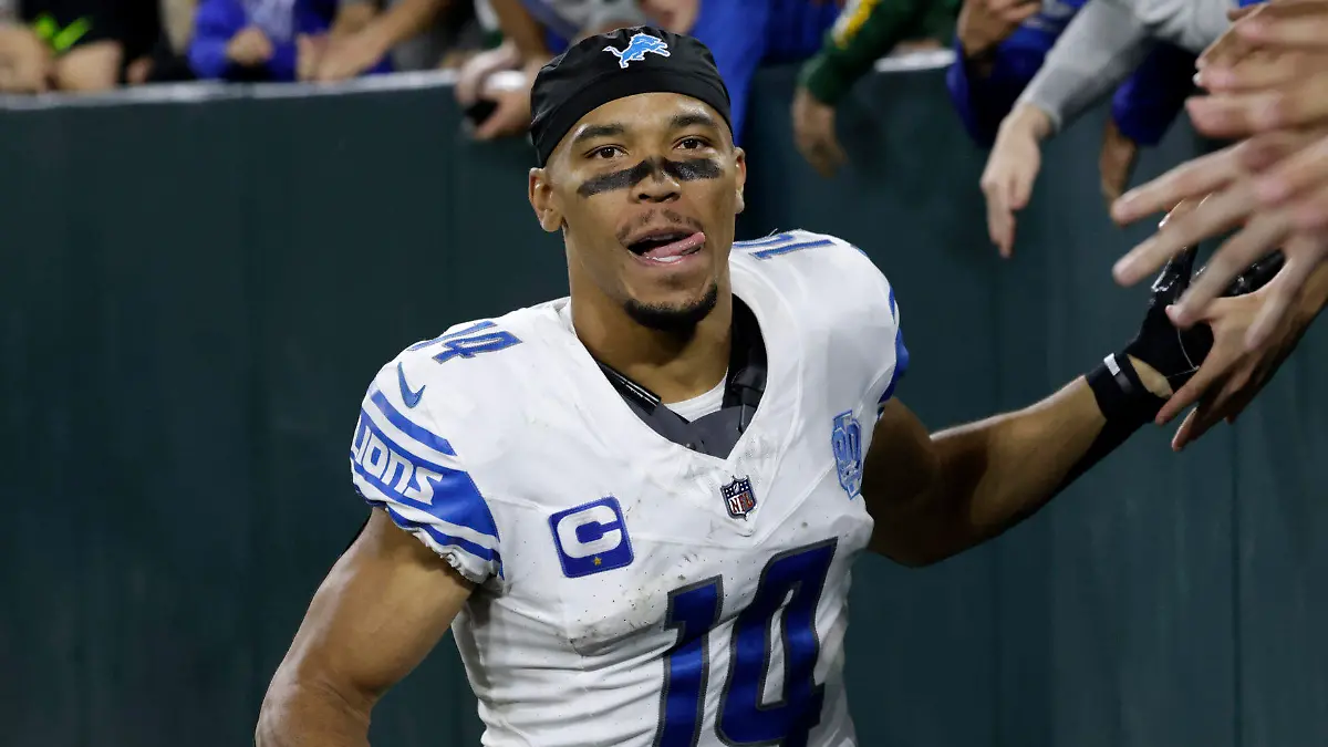 Detroit Lions wide receiver Amon-Ra St. Brown (14) celebrates with fans after an NFL football game against the Green Bay Packers, Thursday, Sept. 28, 2023, in Green Bay, Wis. The Lions won 34-20. (AP Photo/Mike Roemer)