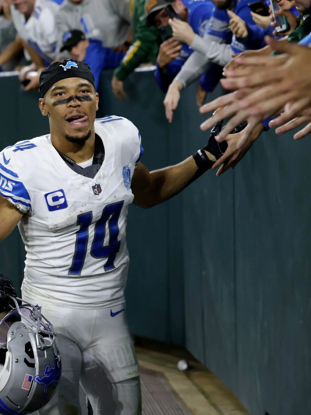 Detroit Lions wide receiver Amon-Ra St. Brown (14) celebrates with fans after an NFL football game against the Green Bay Packers, Thursday, Sept. 28, 2023, in Green Bay, Wis. The Lions won 34-20. (AP Photo/Mike Roemer)