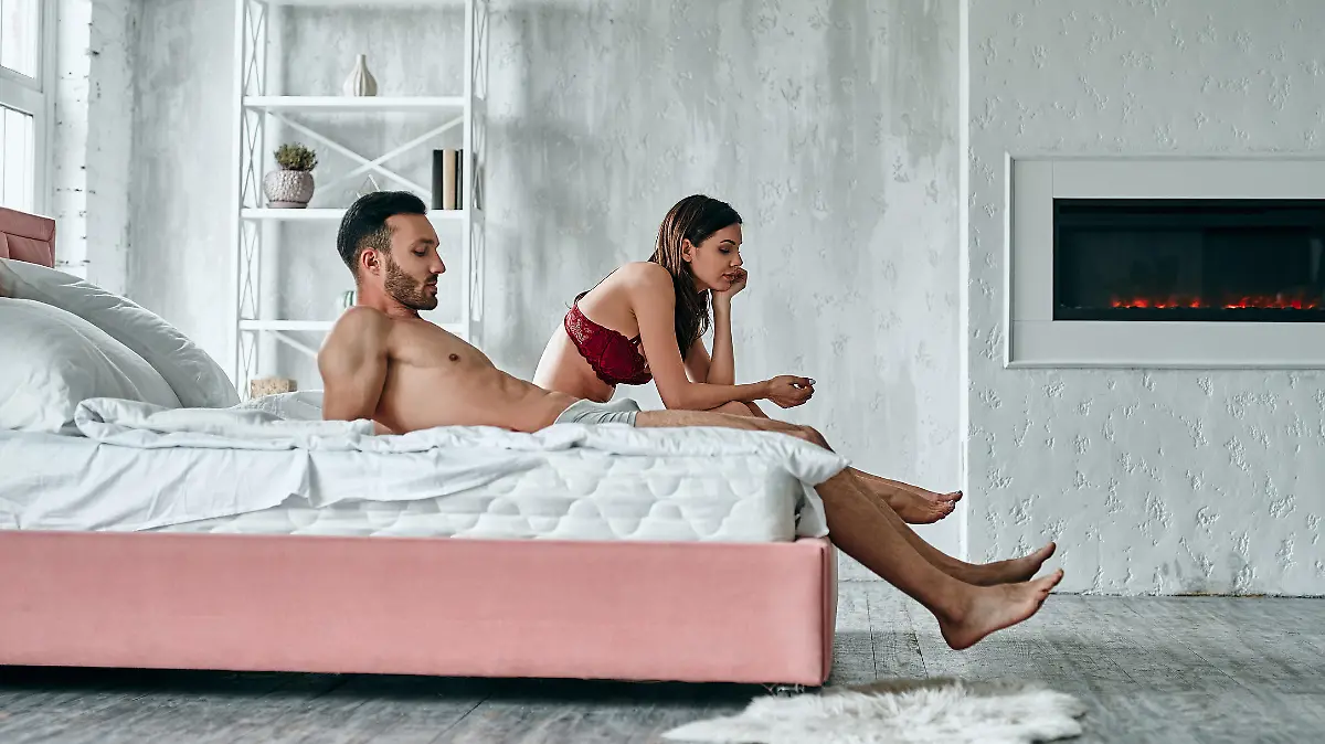 The man and woman sitting on the bed