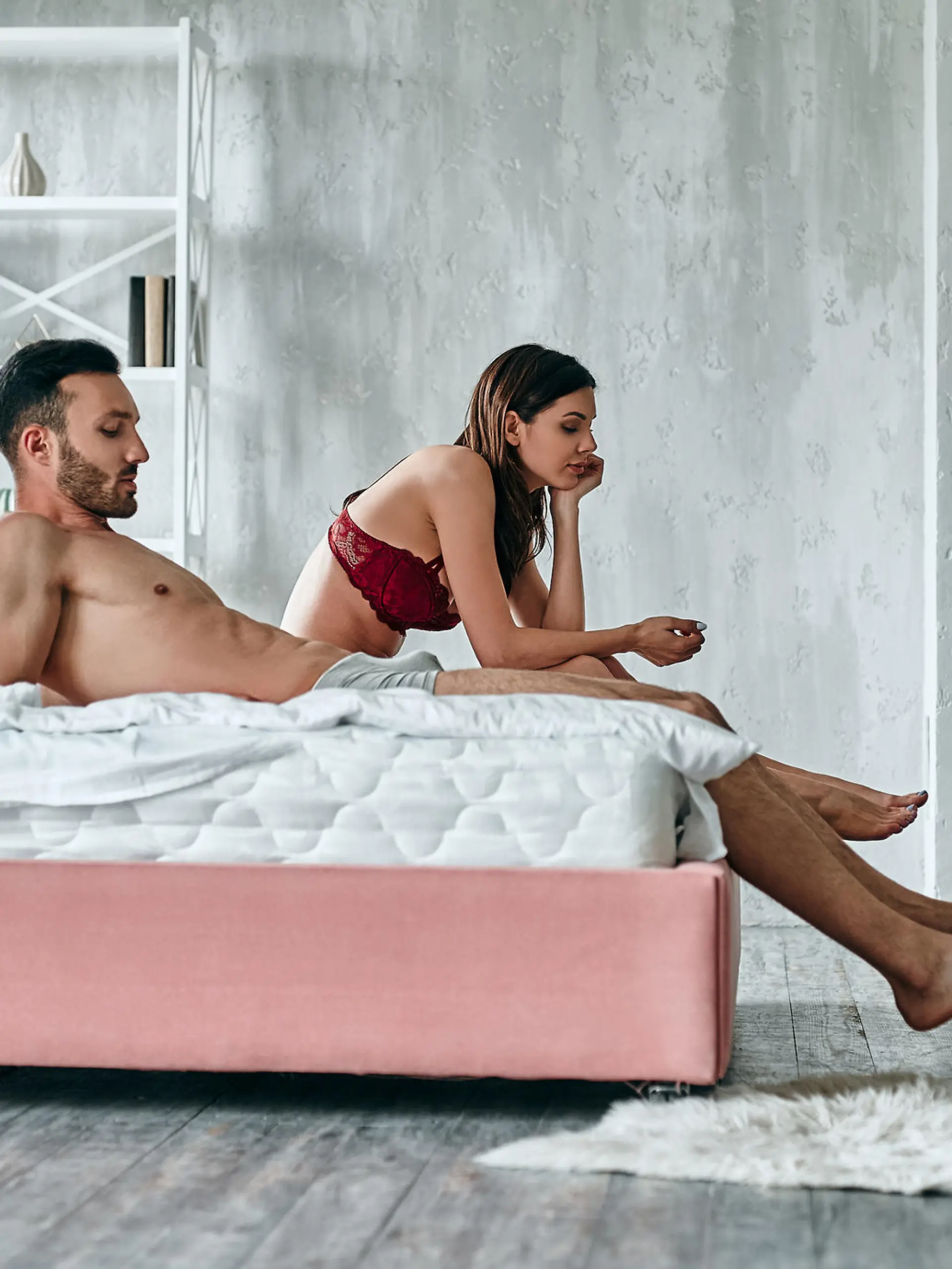 The man and woman sitting on the bed