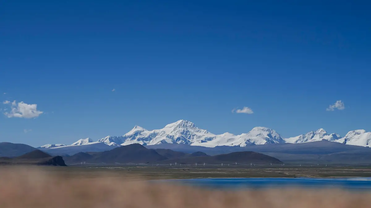 In this photo released by Xinhua News Agency, Mount Shishapangma is seen from Baiku Lake in Xigaze, southwest China's Tibet Autonomous Region on Sept. 2, 2023. American mountaineer Anna Gutu and a Nepalese guide Mingmar Sherpa were confirmed dead Sunday, Oct. 8, after avalanches struck the slopes of a Tibetan mountain, while two others remained missing, according to Chinese media reports. (Chen Zepeng/Xinhua via AP)