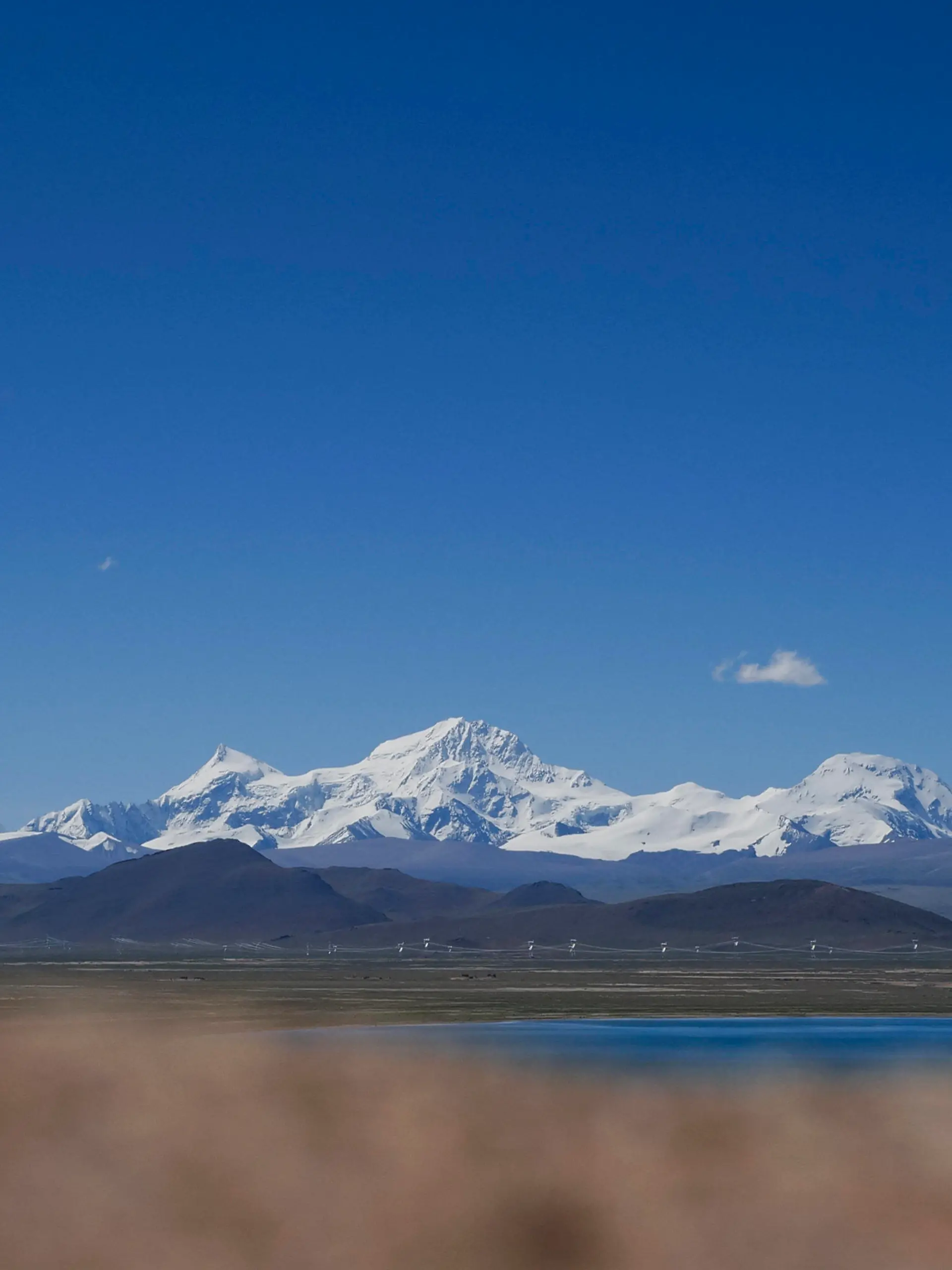 In this photo released by Xinhua News Agency, Mount Shishapangma is seen from Baiku Lake in Xigaze, southwest China's Tibet Autonomous Region on Sept. 2, 2023. American mountaineer Anna Gutu and a Nepalese guide Mingmar Sherpa were confirmed dead Sunday, Oct. 8, after avalanches struck the slopes of a Tibetan mountain, while two others remained missing, according to Chinese media reports. (Chen Zepeng/Xinhua via AP)
