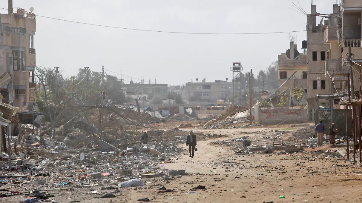 FILE - A man walks down a destroyed street in the Salahaddin in Rafah, southern Gaza strip following Israeli strikes on Hamas targets, Saturday, Jan. 17, 2009. (AP Photo/Ben Curtis, File)