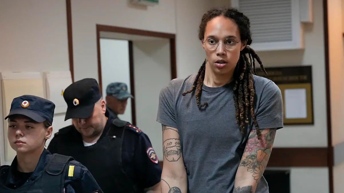 FILE - WNBA star and two-time Olympic gold medalist Brittney Griner is escorted from a courtroom after a hearing in Khimki just outside Moscow, Russia, on Aug. 4, 2022. The jailed American basketball star has been moved to a penal colony in Russia, her legal team said Wednesday, Nov. 9, 2022.(AP Photo/Alexander Zemlianichenko, File)