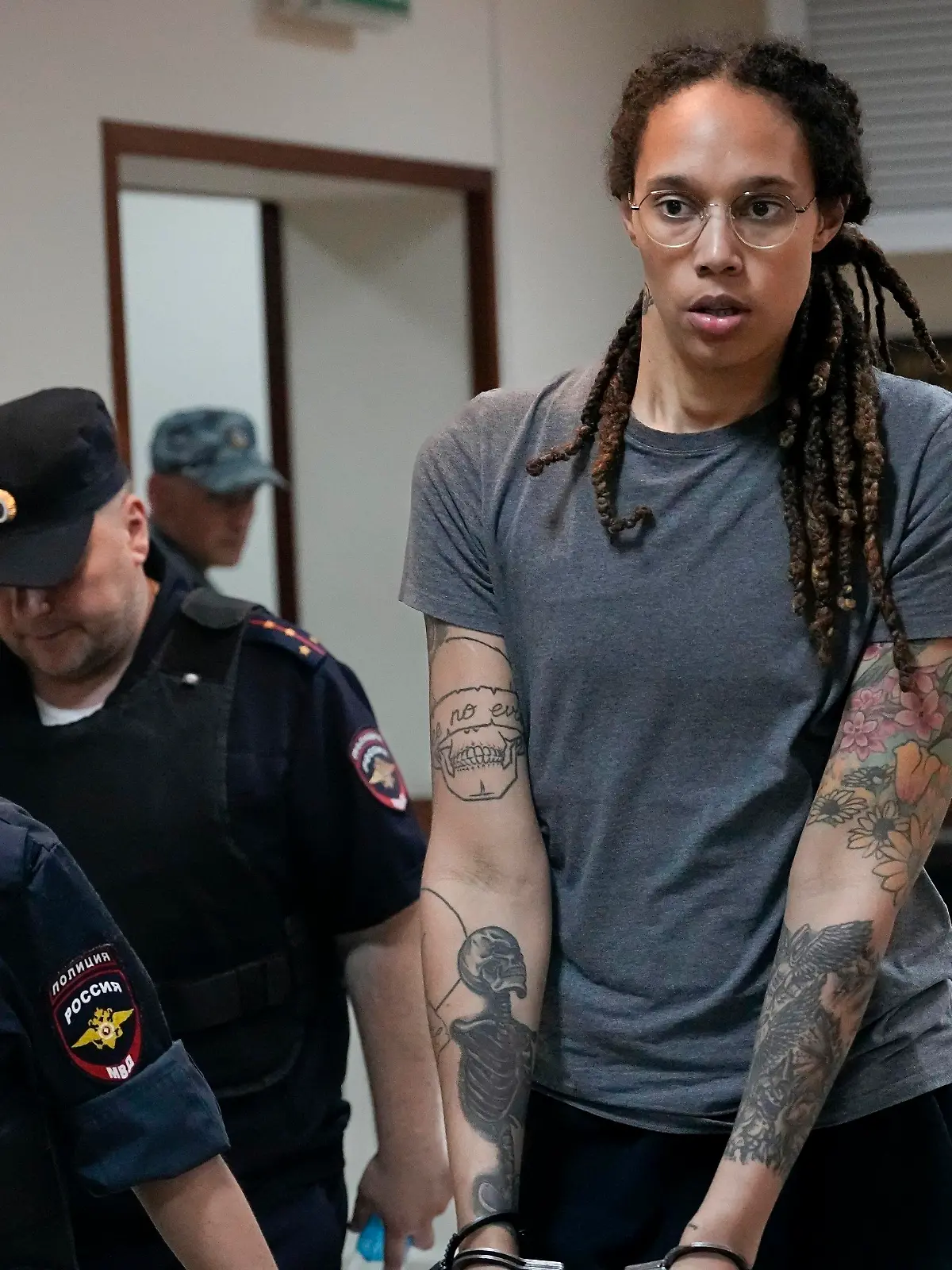 FILE - WNBA star and two-time Olympic gold medalist Brittney Griner is escorted from a courtroom after a hearing in Khimki just outside Moscow, Russia, on Aug. 4, 2022. The jailed American basketball star has been moved to a penal colony in Russia, her legal team said Wednesday, Nov. 9, 2022.(AP Photo/Alexander Zemlianichenko, File)
