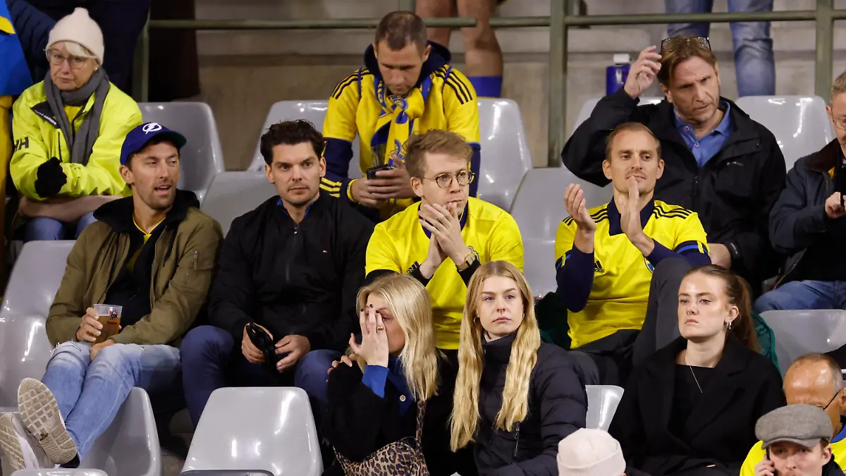 Sweden supporters react on stands during the Euro 2024 group F qualifying soccer match between Belgium and Sweden at the King Baudouin Stadium in Brussels, Monday, Oct. 16, 2023. Two Swedes were killed in a shooting late Monday in central Brussels, police said, prompting Belgium's prime minister and senior Cabinet minister to hunker down at their crisis center for an emergency meeting. (AP Photo/Geert Vanden Wijngaert)