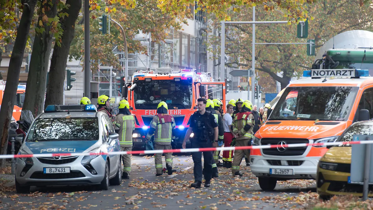 31.10.2022, Berlin: Einsatzfahrzeuge von Polizei und Feuerwehr stehen an der Bundesallee in Berlin-Wilmersdorf, wo eine Radfahrerin  bei dem Verkehrsunfall mit einem Lastwagen lebensgefährlich verletzt wurde. Die Verletzte sei unter dem Betonmischer eingeklemmt worden, teilte ein Sprecher der Feuerwehr mit. Auch der Lkw-Fahrer wurde bei dem Unfall verletzt. Einsatzkräfte der Berliner Feuerwehr sind nach Angaben eines Sprechers wegen Protesten von Klimademonstranten zudem verspätet am Unfallort eingetroffen. Foto: Paul Zinken/dpa +++ dpa-Bildfunk +++