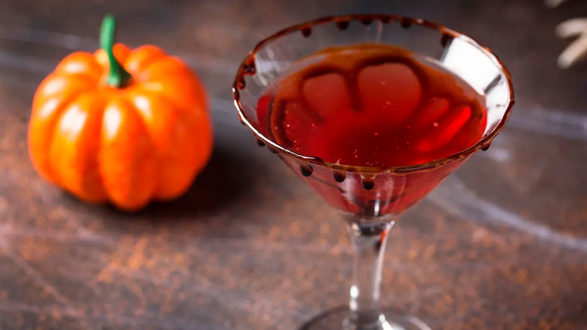 Halloweens drink red martini cocktail with chocolate rim