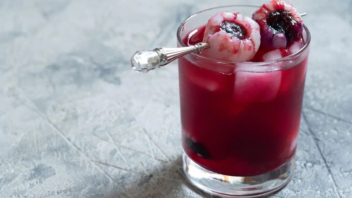 Red halloween cocktail with lychee and blueberry eye