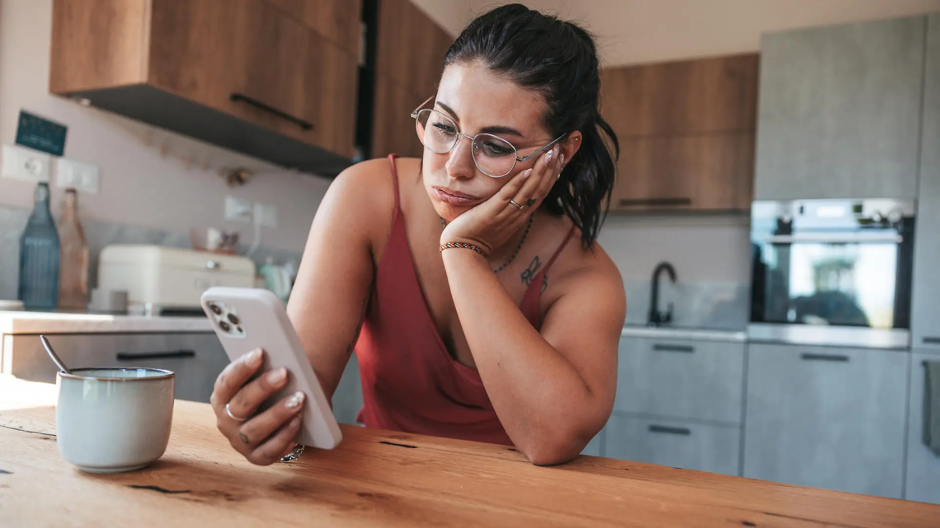 Woman checking phone in the morning having job problems.