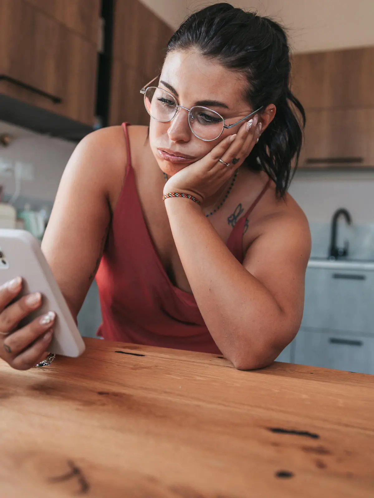 Woman checking phone in the morning having job problems.