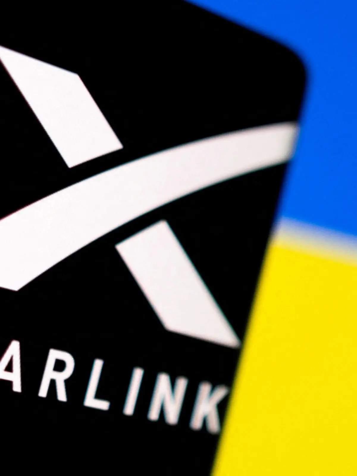 FILE PHOTO: Starlink logo is seen on a smartphone in front of displayed Ukrainian flag in this illustration taken February 27, 2022. REUTERS/Dado Ruvic/Illustration/File Photo