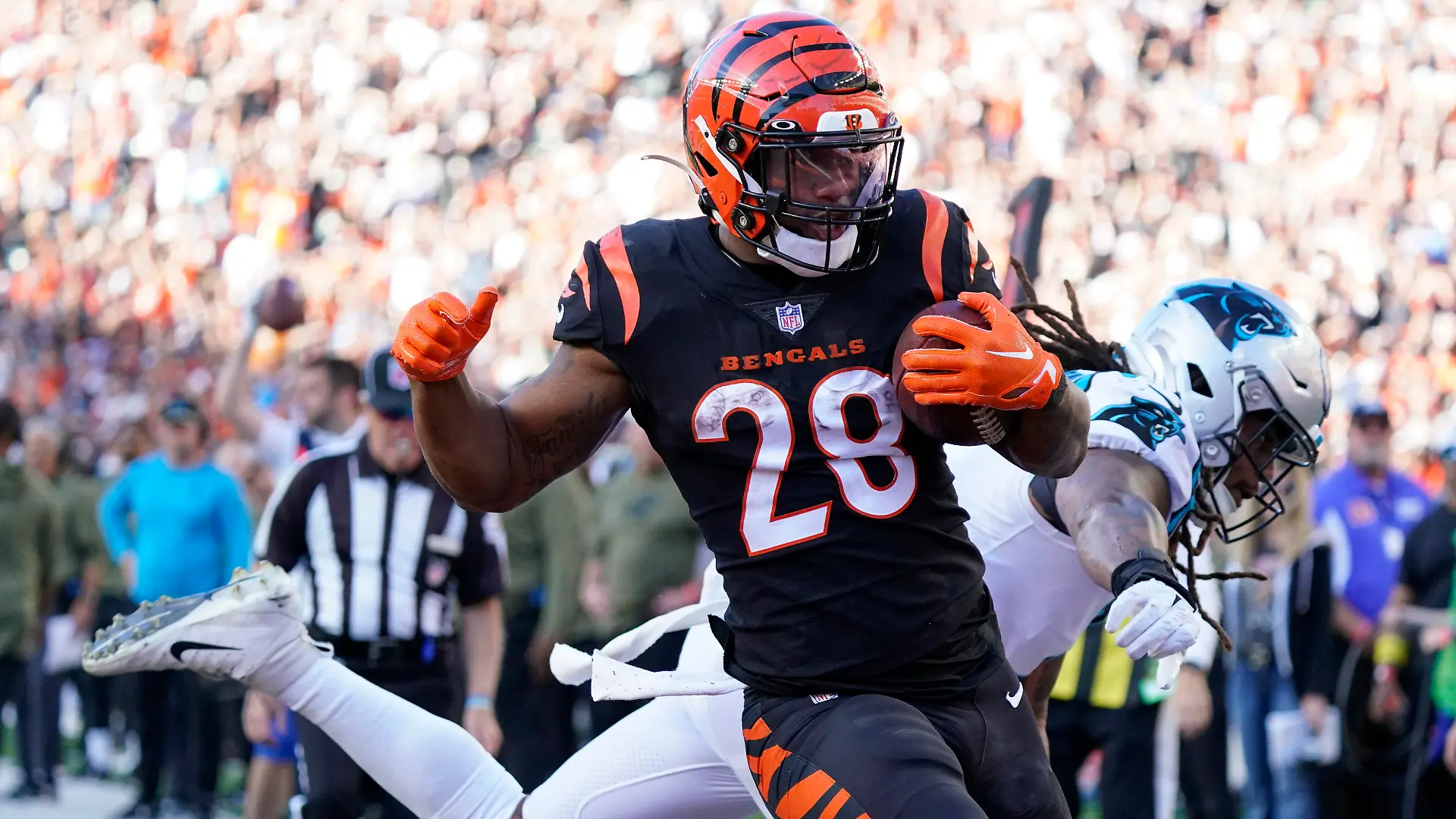 Cincinnati Bengals running back Joe Mixon (28) runs past Carolina Panthers linebacker Shaq Thompson, right, for a touchdown during the second half of an NFL football game, Sunday, Nov. 6, 2022, in Cincinnati. (AP Photo/Joshua A. Bickel)