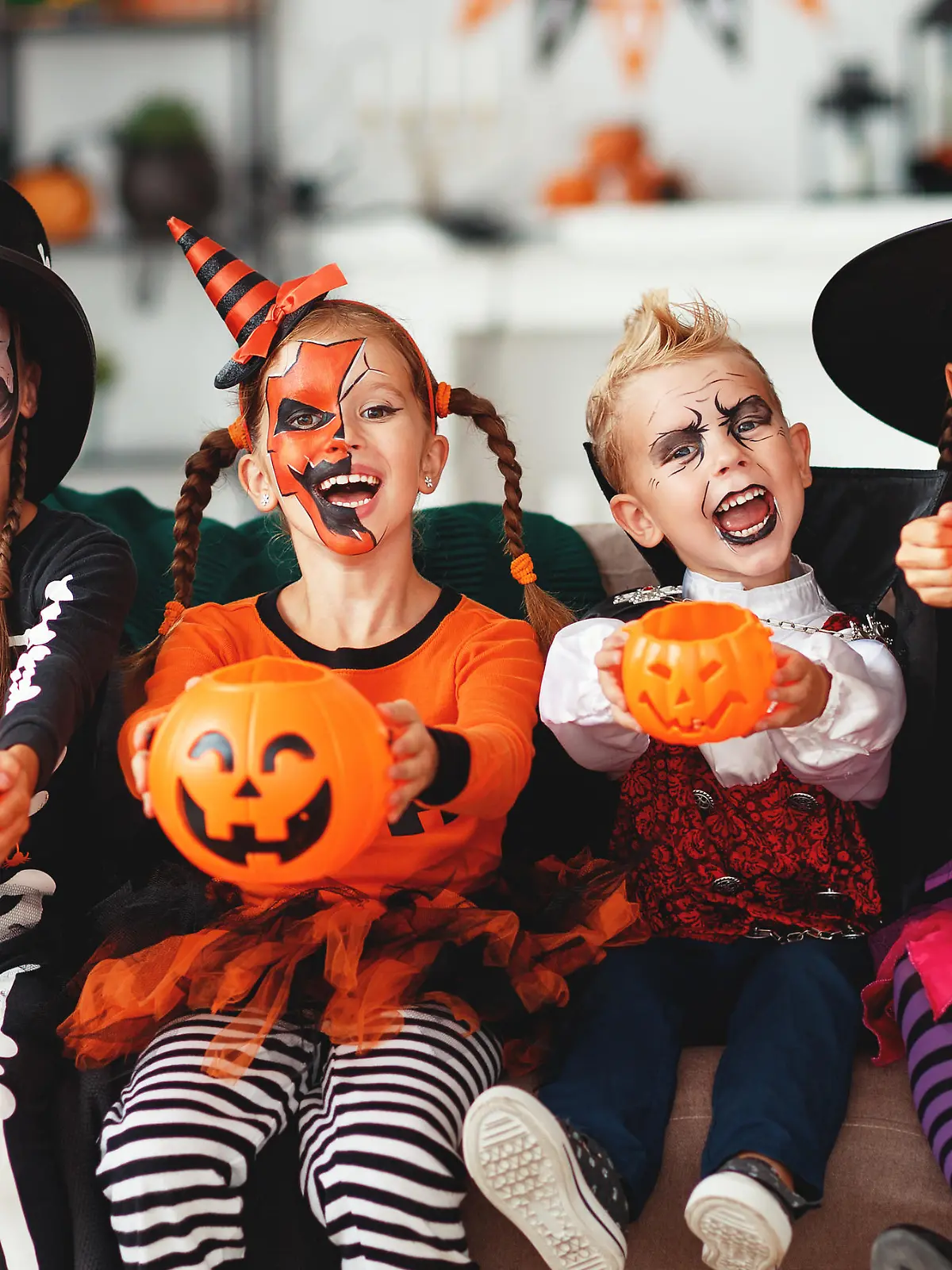 happy Halloween! a group of children in suits and with pumpkins in home