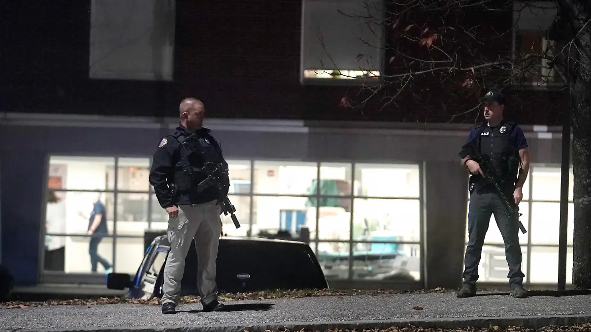 Law enforcement officers carry rifles outside Central Maine Medical Center during an active shooter situation, in Lewiston, Maine, Wednesday, Oct. 25, 2023. (AP Photo/Steven Senne)