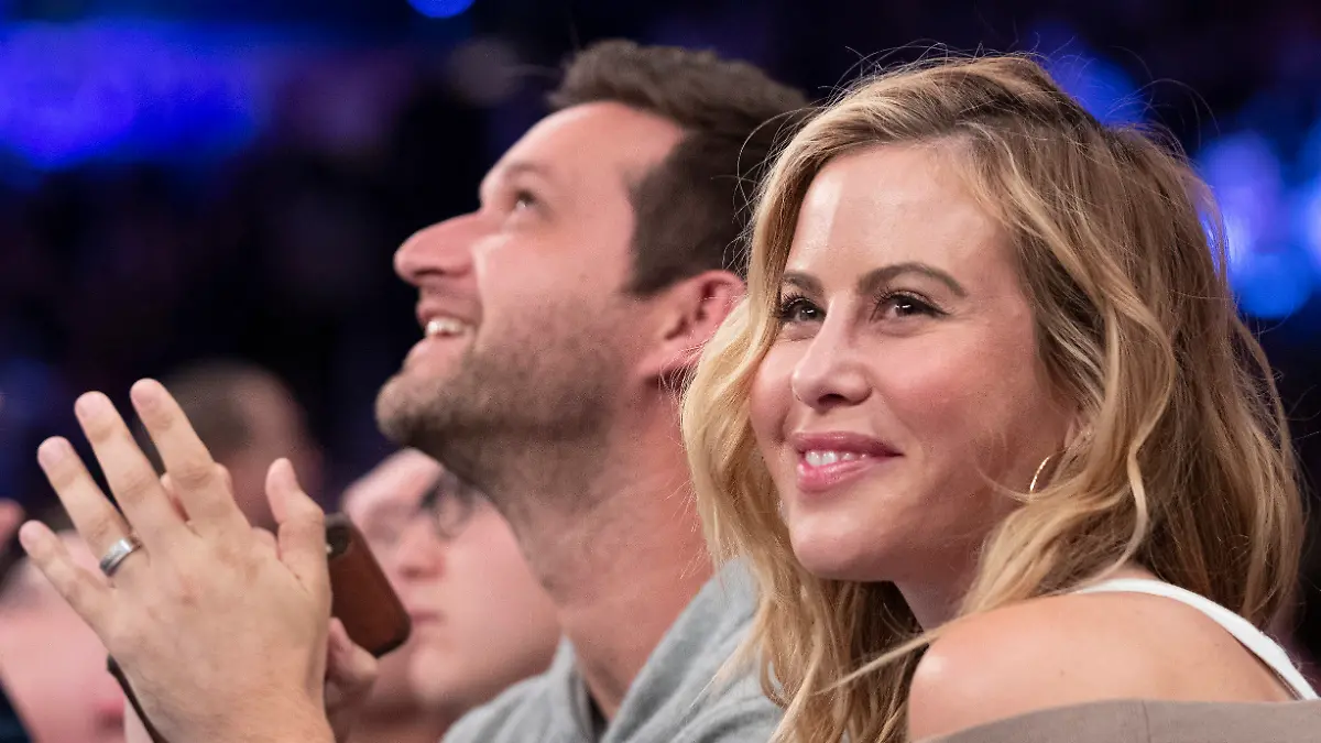 FILE - Former figure skater Tara Lipinski smiles while video of her is shown on the large screen during a timeout in the first half of an NBA basketball game between the New York Knicks and the Cleveland Cavaliers, Sunday, Nov. 10, 2019, at Madison Square Garden in New York. Olympic gold medalist Tara Lipinski and her husband, Todd Kapostasy, announced Wednesday, Oct. 25, 2023, that they have welcomed a daughter through a surrogate after several years of infertility.(AP Photo/Mary Altaffer, File)