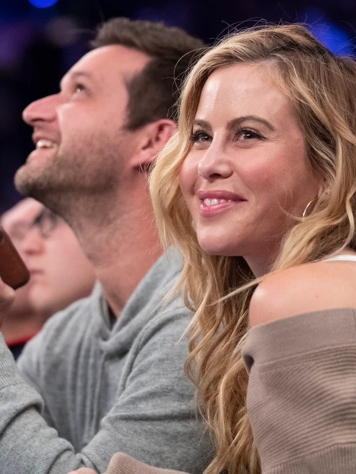 FILE - Former figure skater Tara Lipinski smiles while video of her is shown on the large screen during a timeout in the first half of an NBA basketball game between the New York Knicks and the Cleveland Cavaliers, Sunday, Nov. 10, 2019, at Madison Square Garden in New York. Olympic gold medalist Tara Lipinski and her husband, Todd Kapostasy, announced Wednesday, Oct. 25, 2023, that they have welcomed a daughter through a surrogate after several years of infertility.(AP Photo/Mary Altaffer, File)
