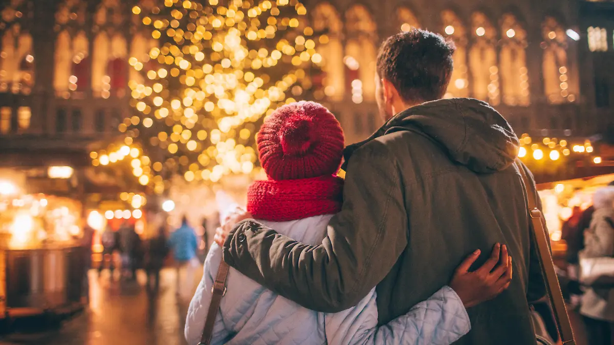 Photo of a young couple enjoy the decoration on Christmas Market, during Christmas Holidays